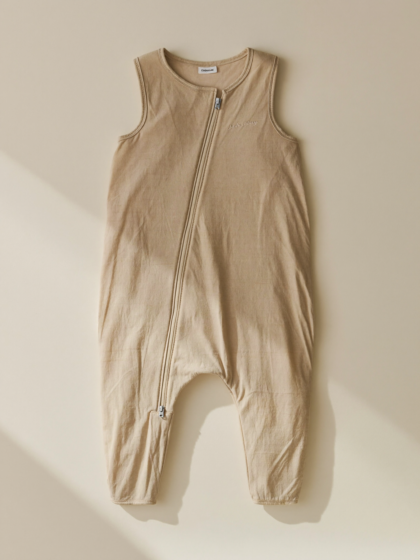 PLACEHOLDER (AI-generated) - Cream baby sleep bag laid flat on cream
