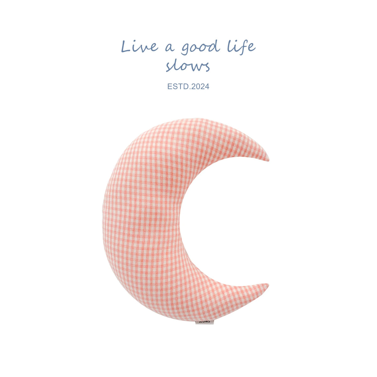 Moon crescent cushion propped on an armchair