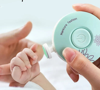 Filing a baby's fingernail with the electric trimmer while they stay still