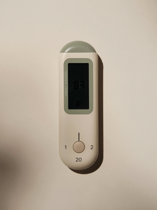 PLACEHOLDER (AI-generated) - Floating bath thermometer on cream