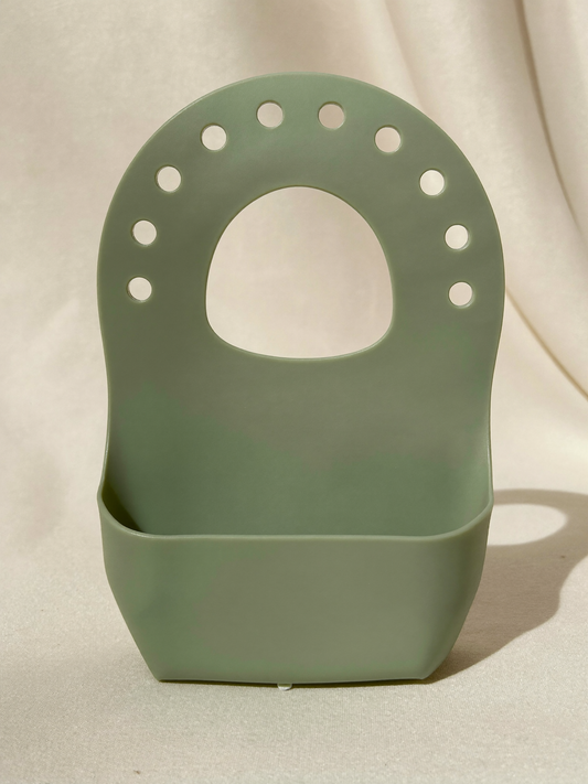 PLACEHOLDER (AI-generated) - Sage silicone bib with catch pocket on cream